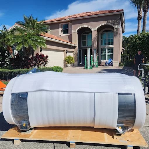 Professional movers handling a grand piano with care